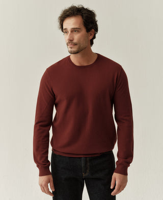 Front detail view of a jasper red merino wool crewneck sweater with a clean silhouette and fine knit construction