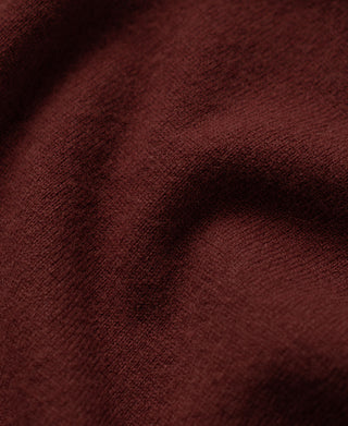Close-up of Jasper Red merino wool knit fabric with fine, textured surface