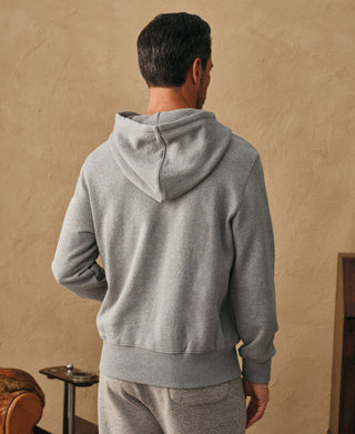 Back view showing the hood and relaxed silhouette of the light gray hoodie