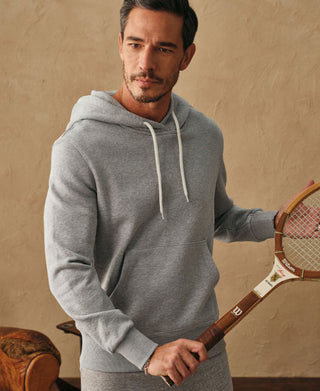 Front lifestyle view of a man wearing the light gray ribbed side panel hoodie