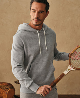 Front lifestyle view of a man wearing the light gray ribbed side panel hoodie