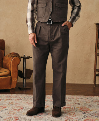 Brown herringbone trousers worn with straight leg and cuffed hem