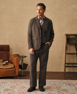Brown relaxed herringbone blazer on model, button-front and flap pockets