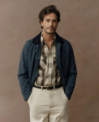 Navy chore jacket with a dark collar, button front, and chest pocket