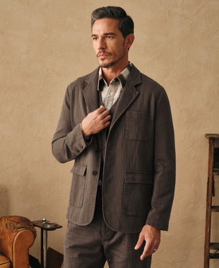 Brown relaxed herringbone blazer with wide lapels and flap chest pocket