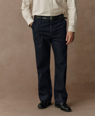Indigo herringbone denim work pants with belt loops and straight-leg silhouette