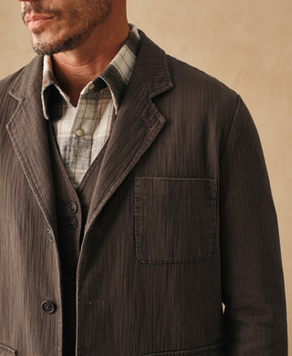 Brown herringbone blazer chest pocket and button placket detail