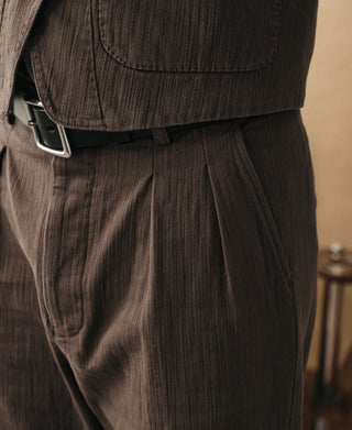 Brown herringbone trousers with double front pleats and waistband belt loops