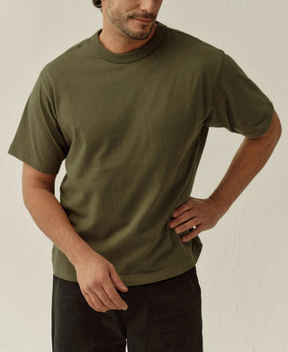 Close view of the olive T-shirt's crew neck, heavyweight jersey, and short sleeves