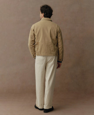Washed khaki cossack jacket, back view with seam details and button cuffs