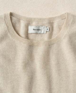 Apricot crewneck merino wool sweater with ribbed neckline and interior brand label