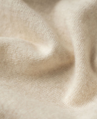 Apricot merino wool sweater knit texture close-up