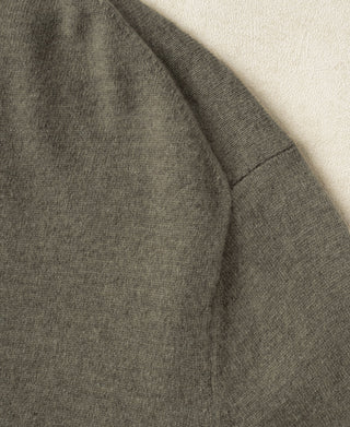Gray-green merino wool crewneck sweater shoulder and sleeve seam detail.