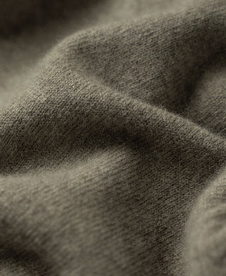 Gray-green merino wool knit fabric texture close-up.