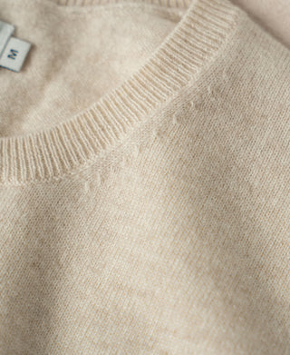 Apricot merino wool sweater with ribbed crew neckline and textured knit
