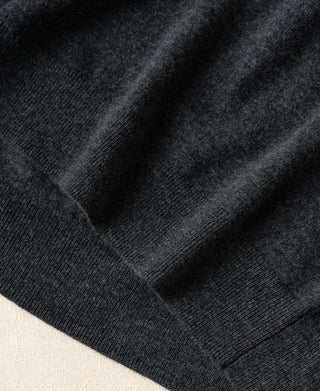 Close-up of heather gray sweater cuff and hem ribbing with knit grain texture