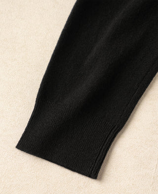 Black merino wool sweater ribbed cuff and hem detail.