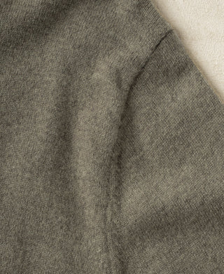 Gray-green merino wool crewneck sweater sleeve with visible seam detail.