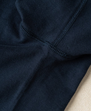 Detailed view of the sleeve seam and smooth loopwheel cotton texture on a vintage-inspired Henley shirt.