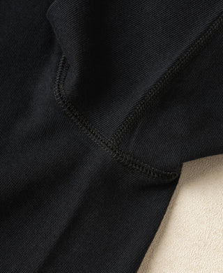 Detailed view of the sleeve seam and smooth loopwheel cotton texture on a vintage-inspired Henley shirt.