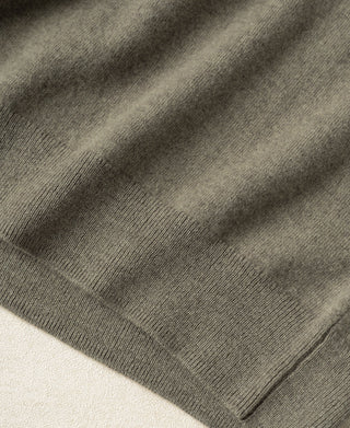 Gray-green merino wool sweater hem with ribbed knit band.