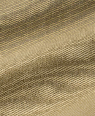Washed khaki duck canvas fabric close-up, woven texture