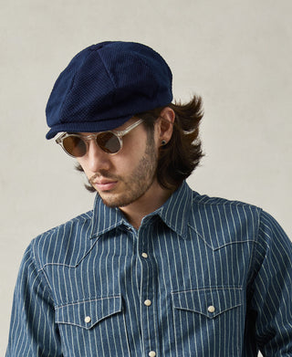 lifestyle shot of Indigo-Dyed Sashiko Newsboy Cap