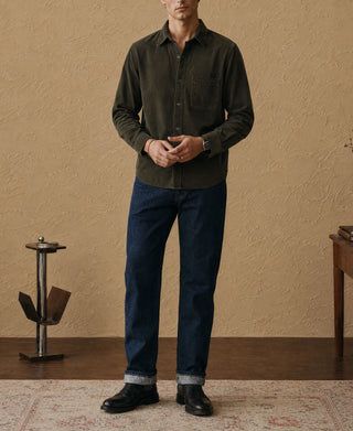 Man wearing dark green corduroy work shirt with button front and long sleeves