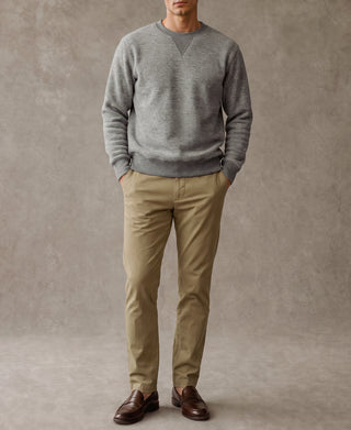 Heather gray crewneck sweatshirt worn with tan pants