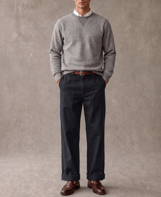 Navy deck pants worn with brown belt and leather shoes, full-length view