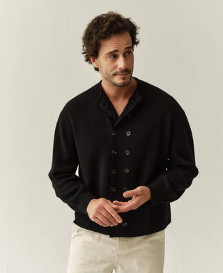 Black double-breasted knit cardigan worn by model with collared neckline