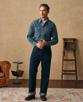 Washed denim western shirt worn by model: long sleeves, snap buttons, chest pockets