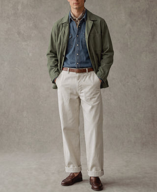White deck pants with button fly, side pockets, and cuffed hems