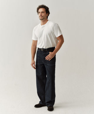 Indigo herringbone denim fatigue pants with buckle waistband and straight legs