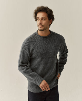Man wearing a gray wool mock neck sweater with ribbed chest and cuffs
