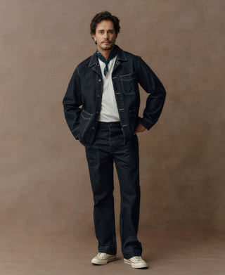 Indigo herringbone denim work jacket with button front and chest pockets