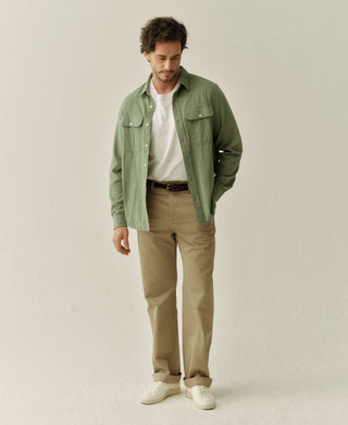 Man wearing sage green brushed flannel work shirt with button-front and chest pockets.