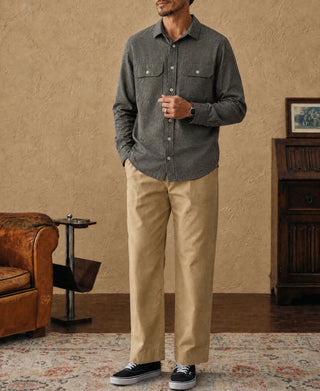 Dark gray work shirt worn with beige pants and buttoned chest pockets