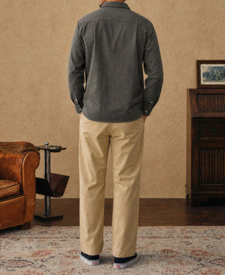 Dark gray work shirt back view, worn with beige pants
