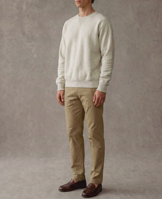 Light gray crewneck sweatshirt with long sleeves, ribbed cuffs and hem