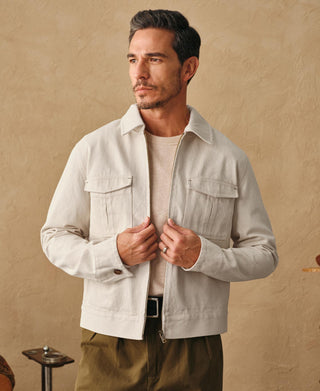 Natural twill jacket on model: stand collar and flap chest pockets, worn closed.