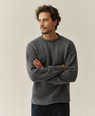 Gray wool mock neck sweater shown on a model, with ribbed chest and hem