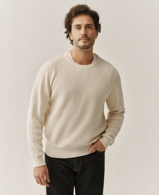 Natural cotton knit sweater with ribbed crew neck, cuffs, and hem, shown from the front.