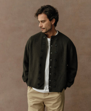 Olive double-breasted knit cardigan with dark button placket, long sleeves