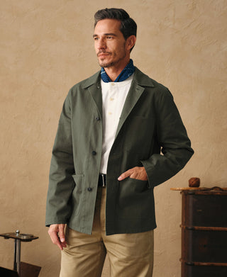 Olive field jacket with flap chest pockets, side hand pockets, and button front