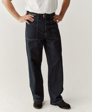 Indigo herringbone denim fatigue pants with center buckle and front pockets