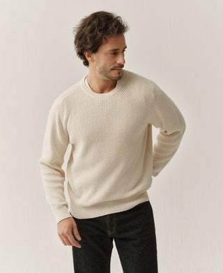 Natural rib-knit cotton sweater with crew neck and ribbed trim, shown at a three-quarter angle.