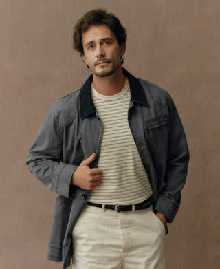 Gray-blue canvas jacket front view with chest pocket and buttons