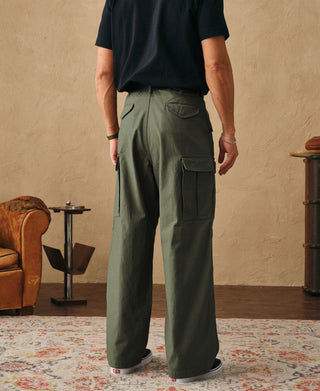 Olive field cargo pants on model, rear view with cargo pocket and belt loops