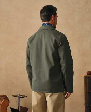 Olive field jacket back view with button-front placket and stand collar
